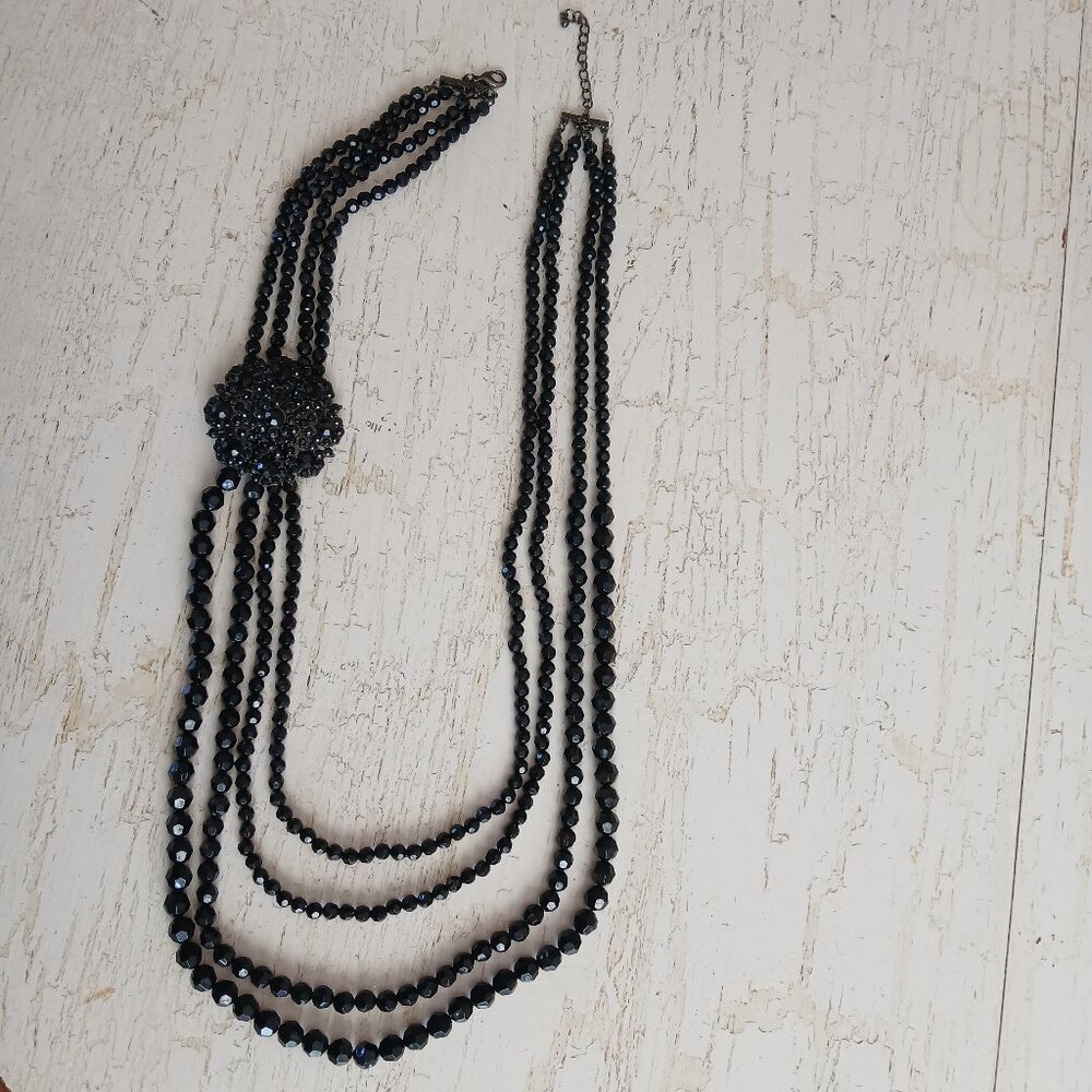 Black 4 Strand Bead Necklace 38 in L with 2 in. Brooch-like Bead Cluster